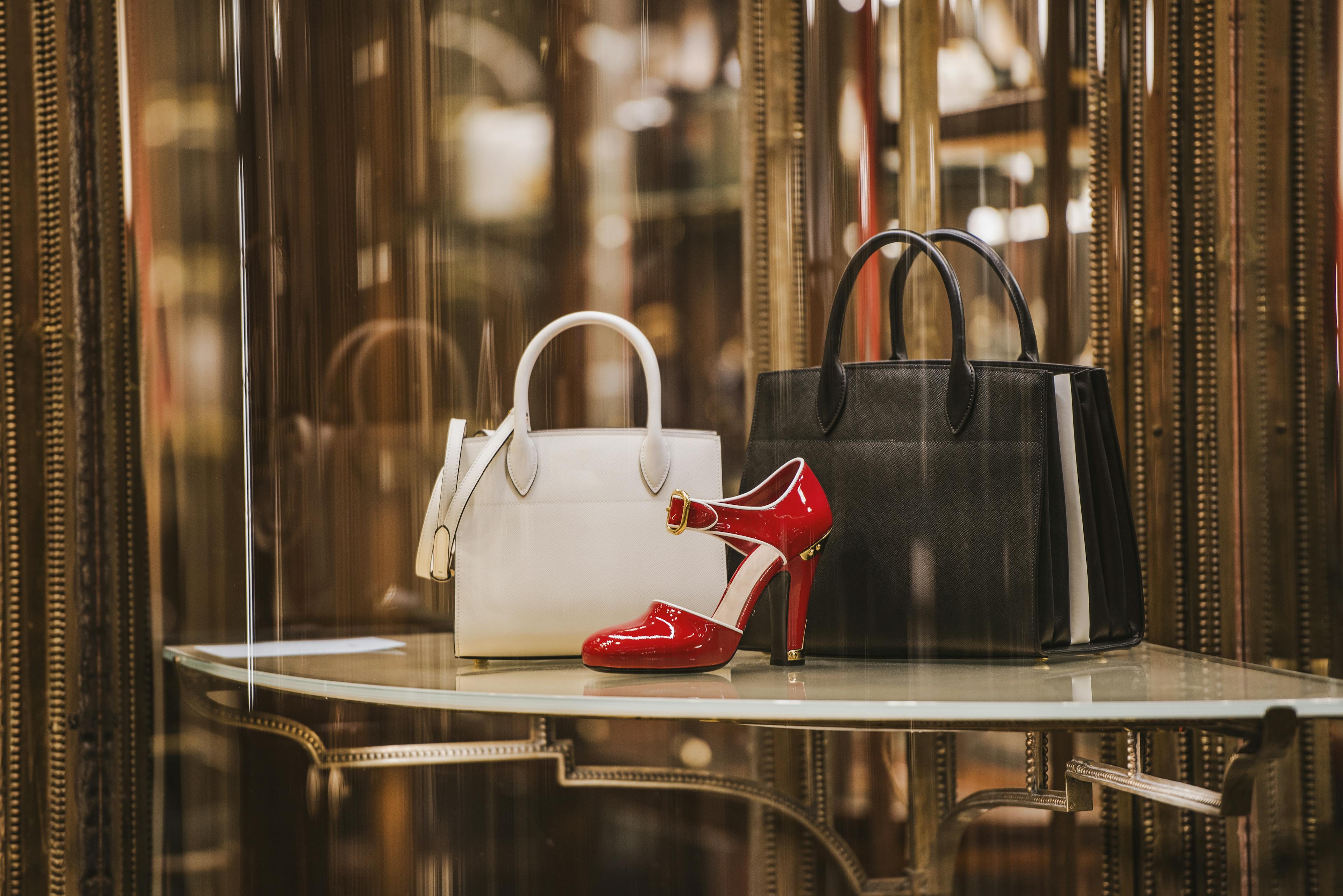 luxury brand store window display of shoes and hand bags