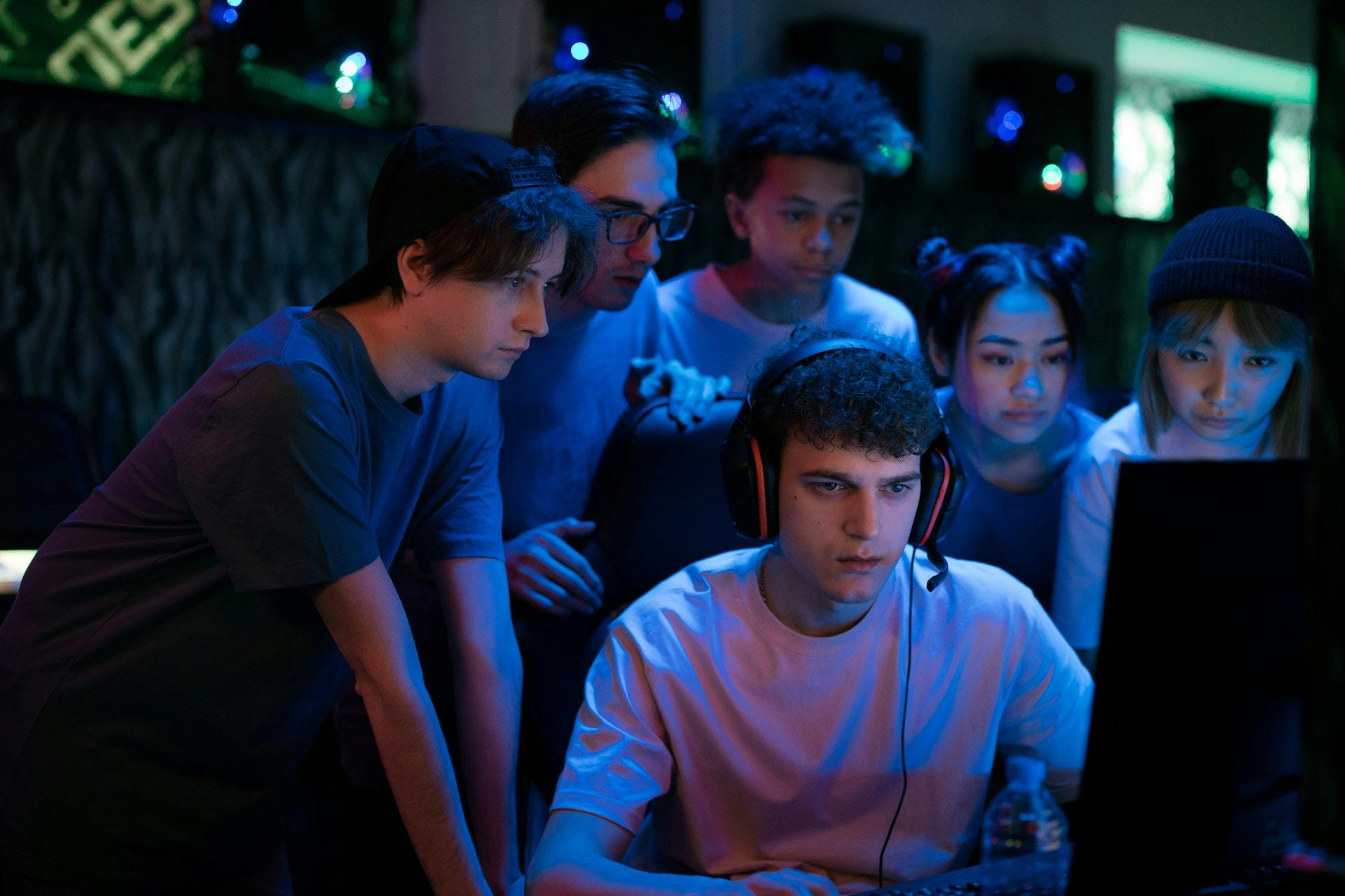 group of young people gaming at a desktop computer