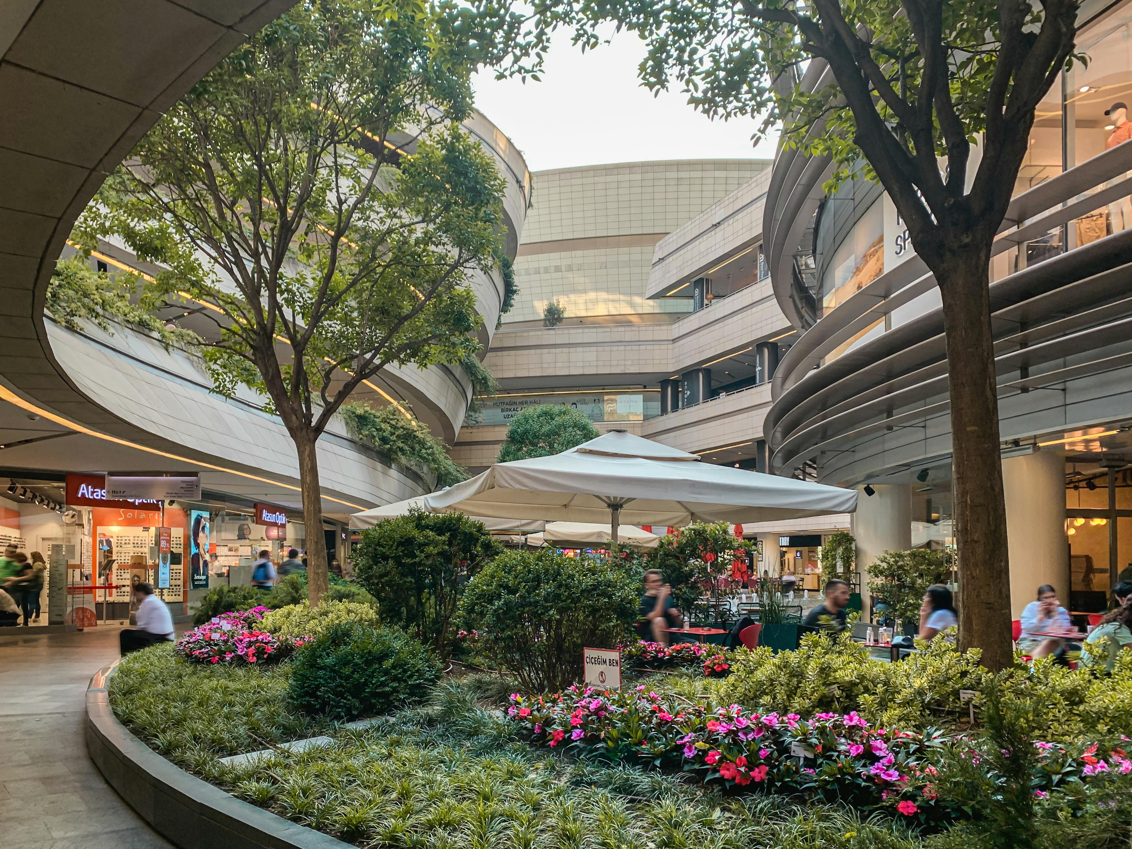 open-air mall with gardens and a restaurant 