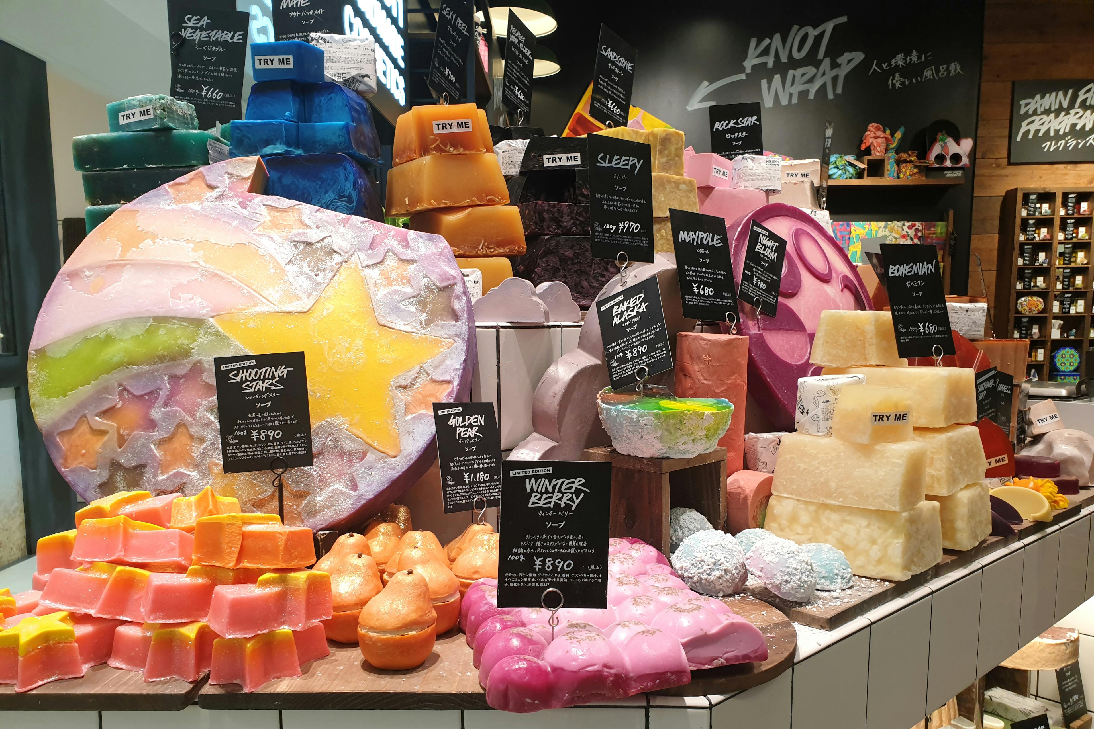 stacks of bath bombs and soaps inside a LUSH store