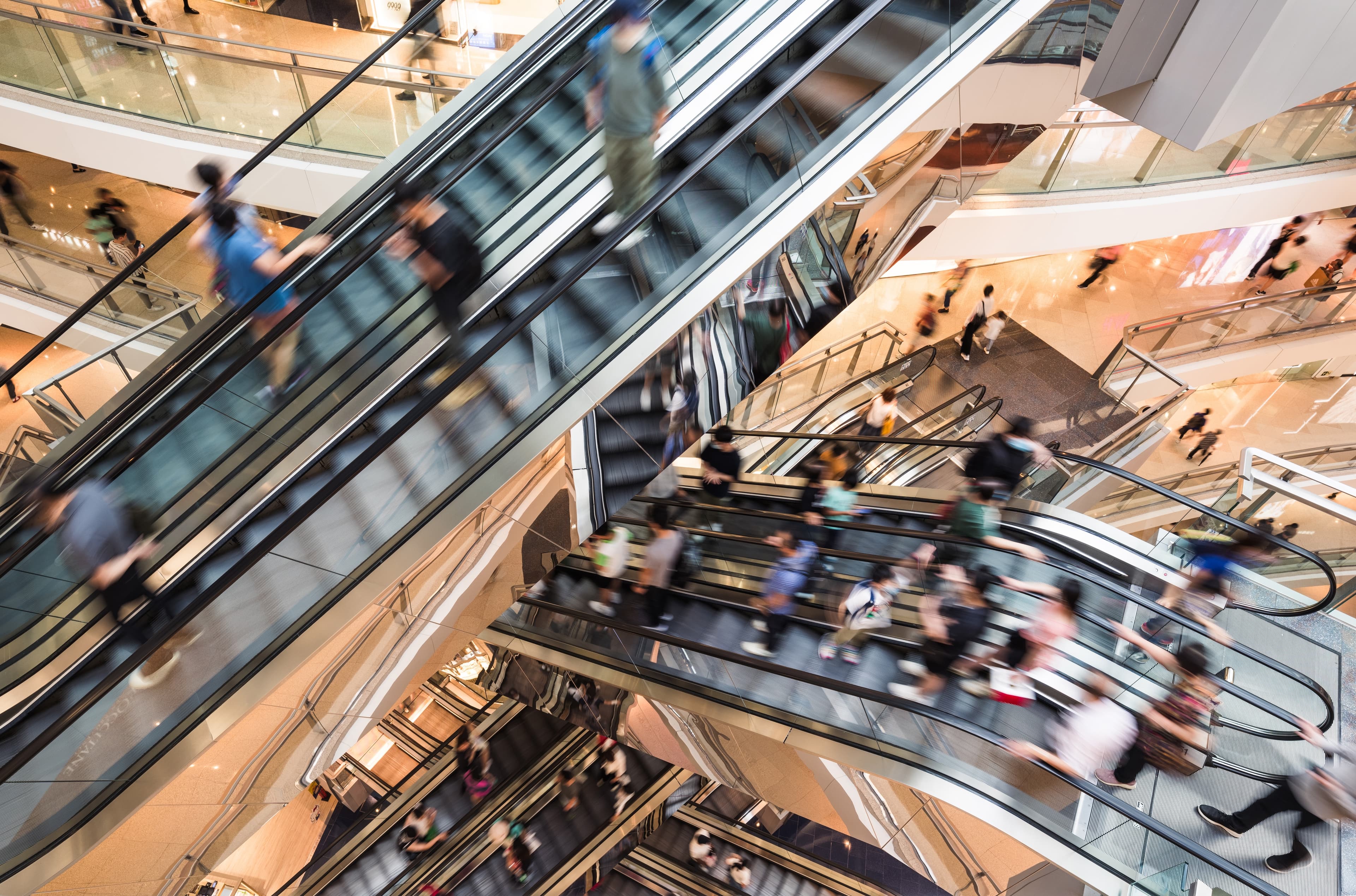 Motion blur people on escalator at urban shopping mall in Hong Kong
