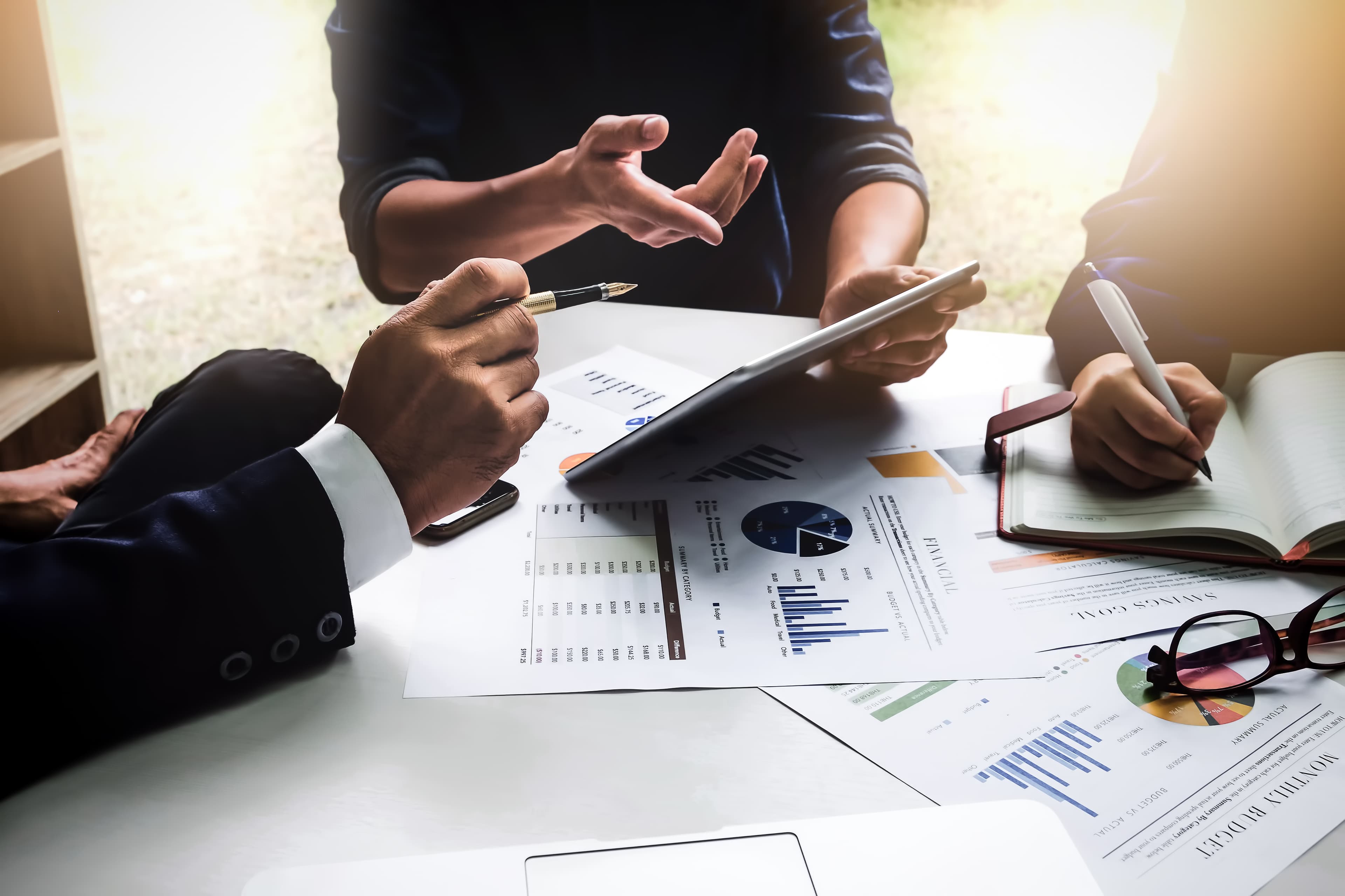 professionals sitting at a table discussing data visualizations 