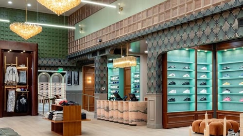 Shoe Palace store interior with teal-lit sneaker wall displays
