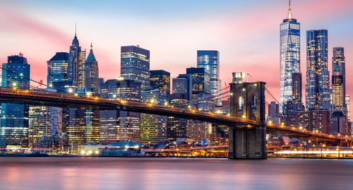 New York City skyline at dusk with the Brooklyn Bridge