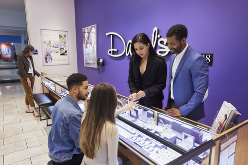 sales associates helping customers in a Daniel's Jewelers store