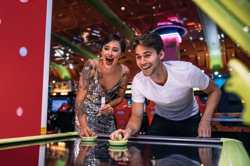couple playing arcade game at dave & buster's location