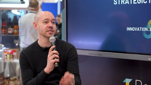 Jimmy Elzaky of Toska Spa & Facial Bar speaking at the RetailNext booth at NRF 2026